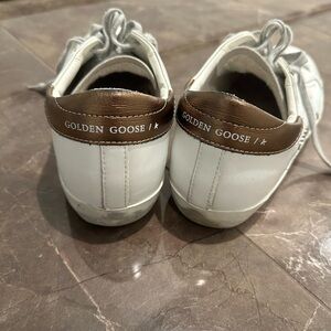 Golden Goose white sneaker with gold leather trim